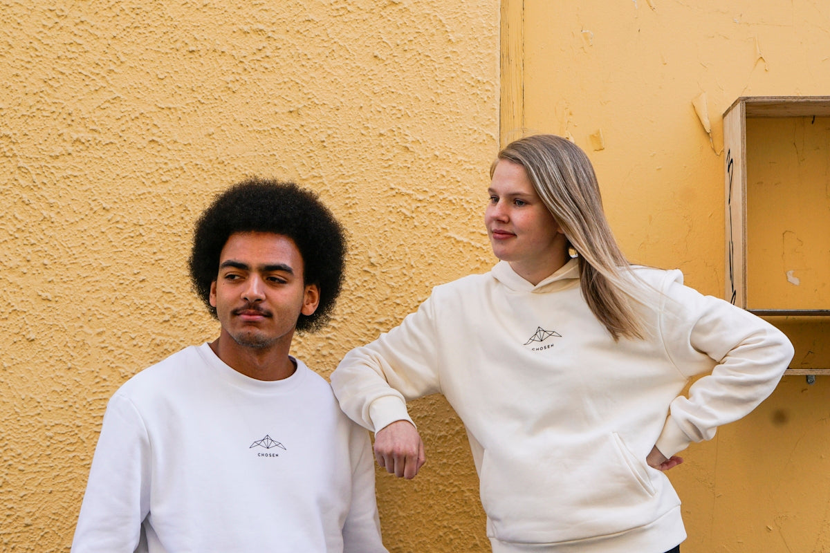 man in white crew neck shirt standing beside woman in white long sleeve shirt
